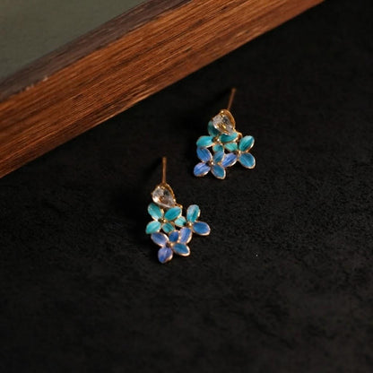 Hydrangea stud earrings with iridescent blue parrot feather florets and a gold plated heart stud